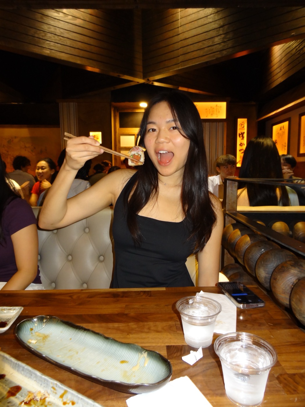 Emma enjoying sushi at a restaurant